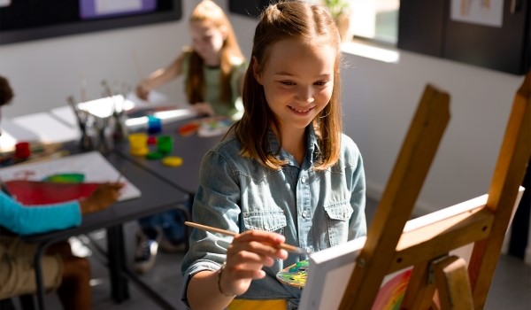 Young girl in a class painting 