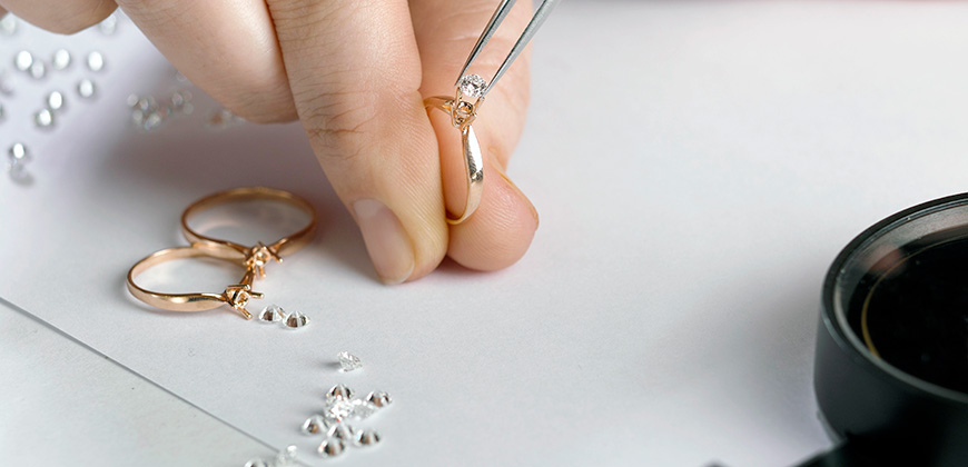 jeweler pieces together diamond ring