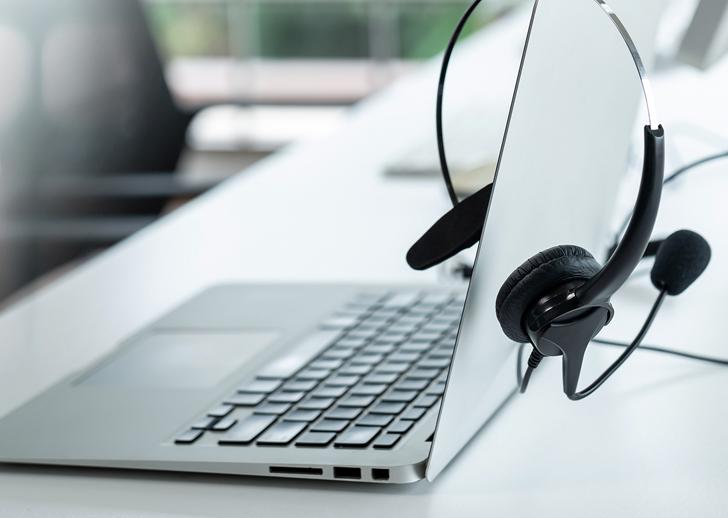 Picture of a laptop with headphones over it