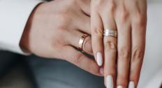 Close up of hands with wedding rings on