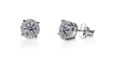 Two diamond studs with earring backs on