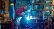 blacksmith working at blacksmith worktable