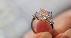 person holding diamond ring with large old mine cut diamond
