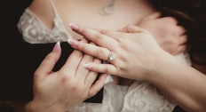 woman with husbands arms crossed over chest wearing diamond ring
